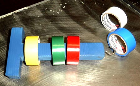 Wooden T shaped holder for rolls of tape.